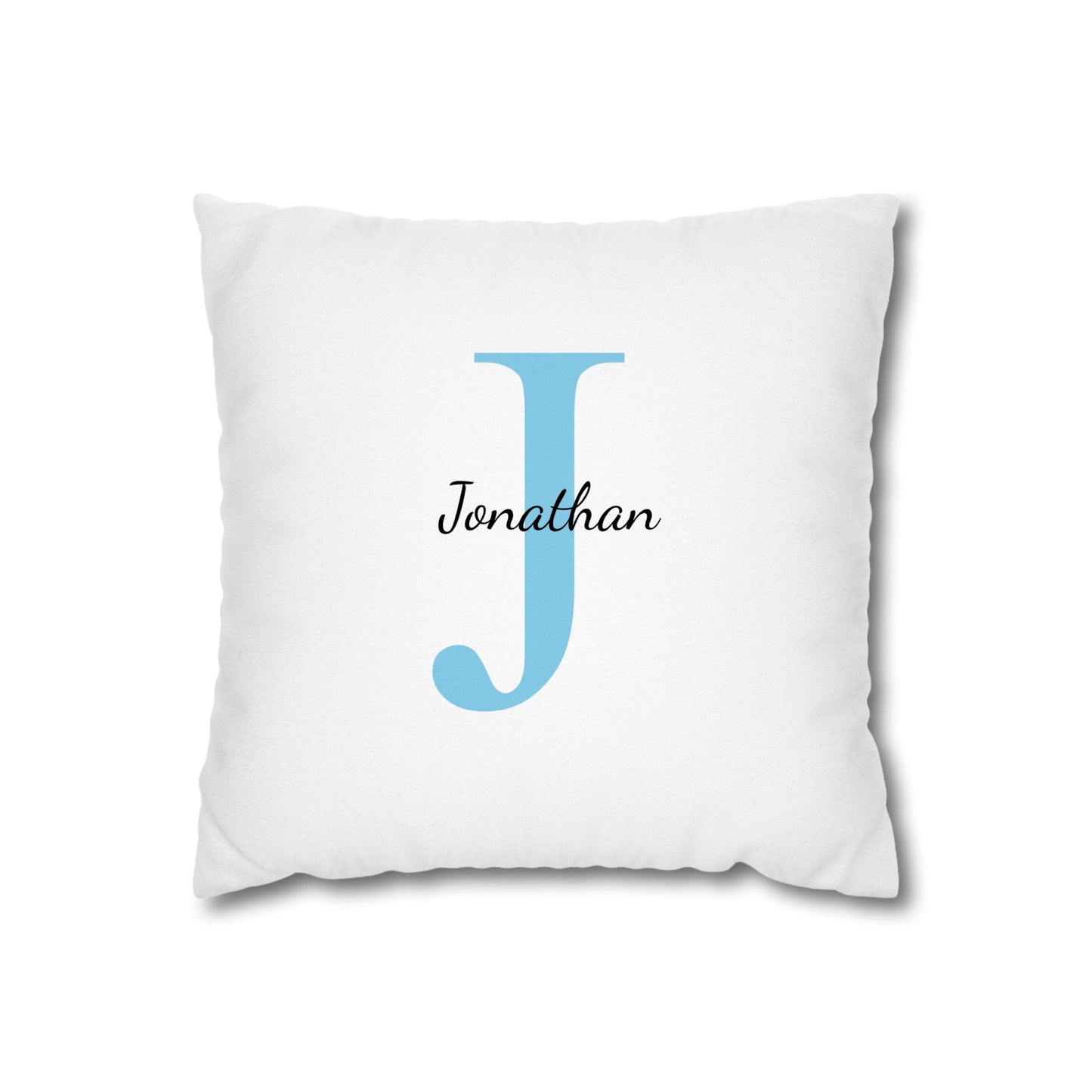 White pillow with a blue letter 'J' and name 'Jonathan' on a white background