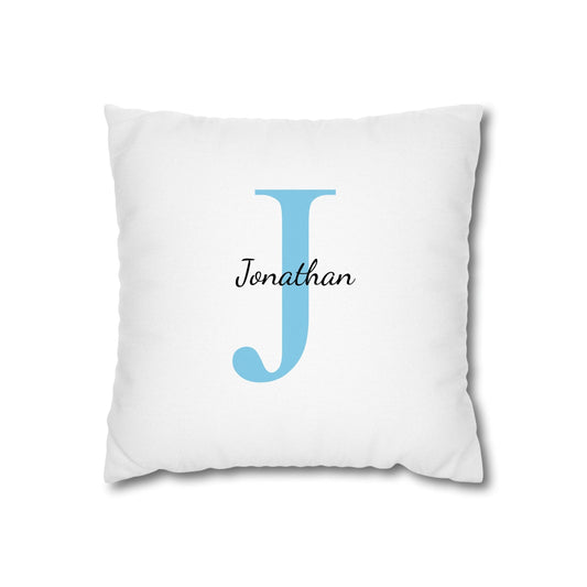 White pillow with a blue letter 'J' and name 'Jonathan' on a white background