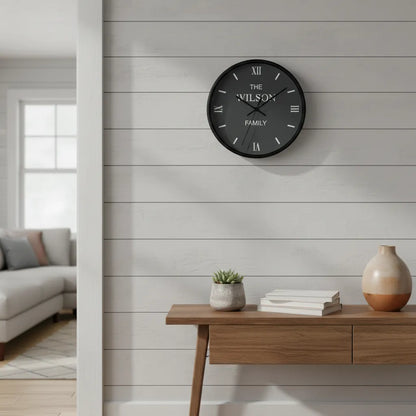 Wall clock with 'The Wilson Family' text on a wall in a home setting.