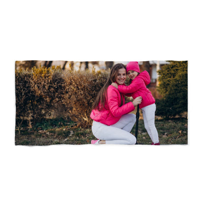 Woman and child wearing pink jackets outdoors with a scenic background