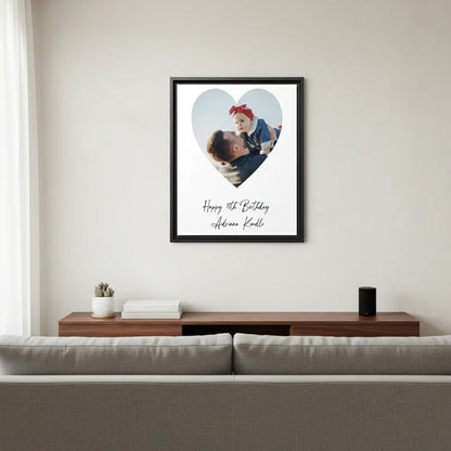 Heart-shaped photo frame with a heart design on a wall above a sofa