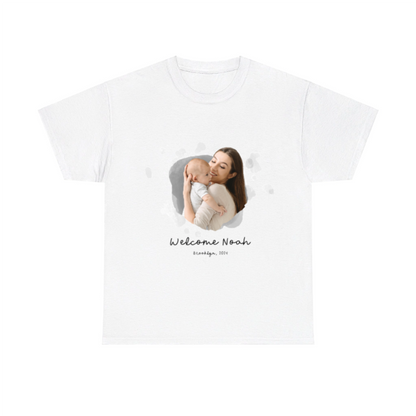 White t-shirt with a printed photo of a woman holding a baby and text 'Welcome Noah' on a white background
