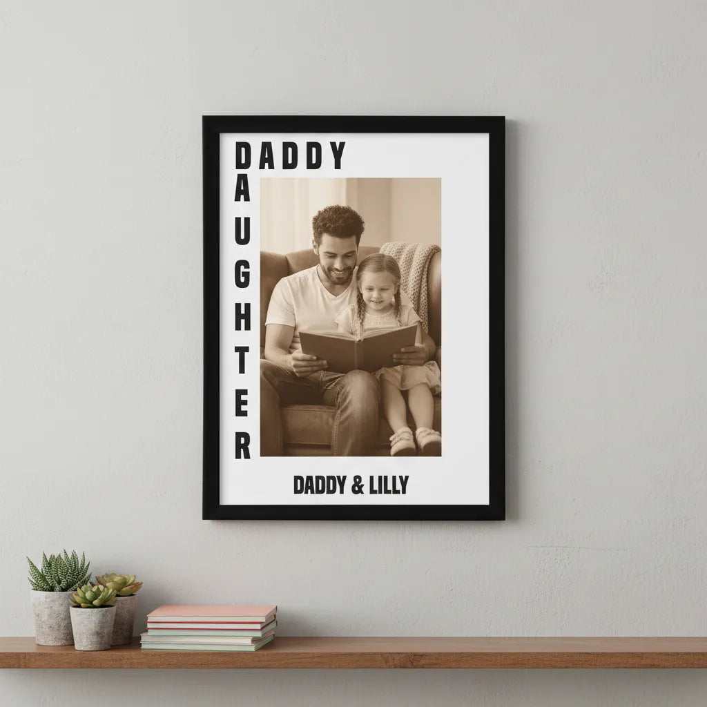 Framed photo of a father and daughter reading together with 'Daddy & Daughter' text on a wall.