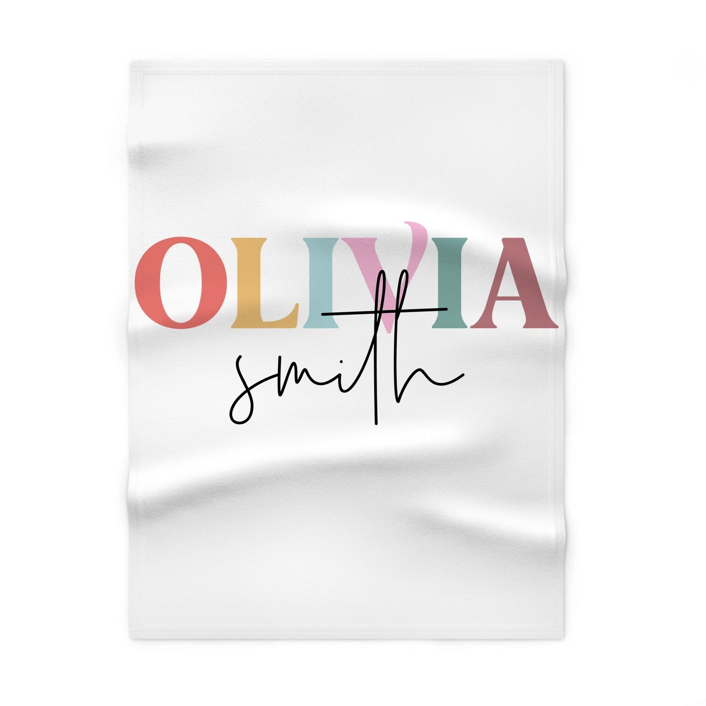 White blanket with colorful text 'OLIVIA' and 'smith'
